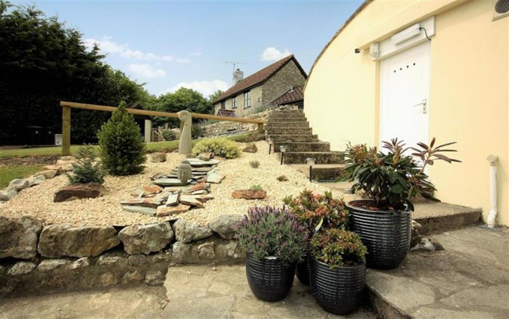 Access to the property is down steps from the parking space at Kowhai Cottage in Charmouth