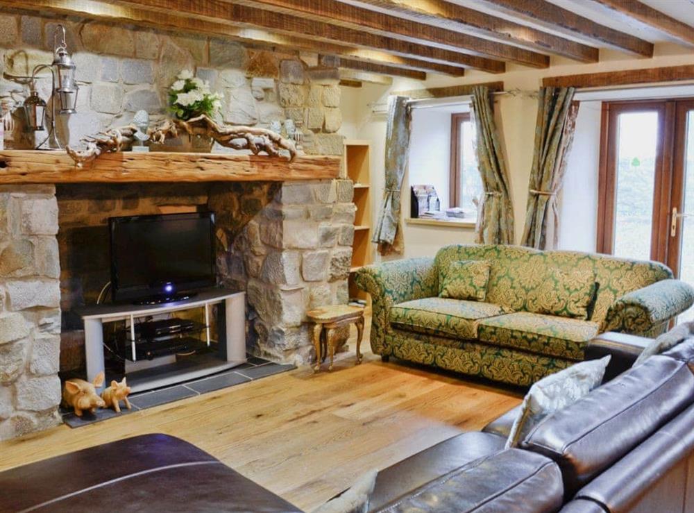 Spacious living room with beams at Kris Kin in Criccieth, Gwynedd., Great Britain
