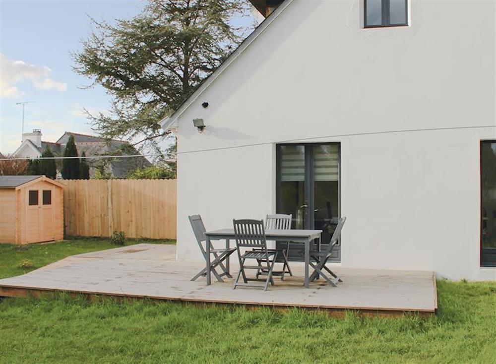 Decked area with table and chairs for alfresco dining at La Maison Blanche in Bénodet, Brittany, France