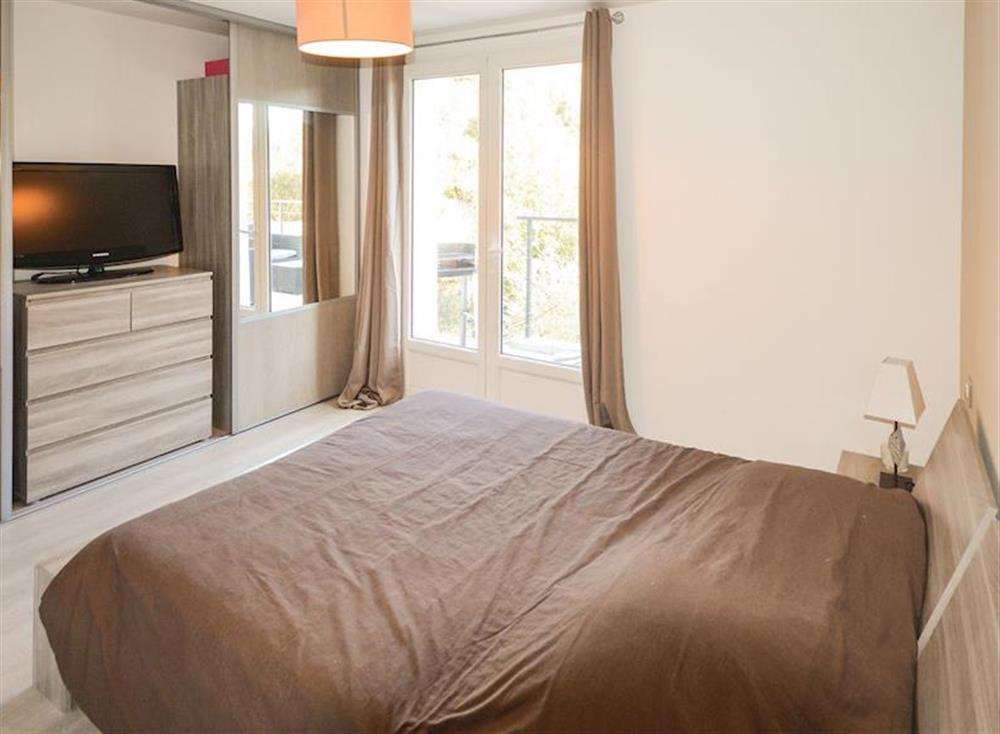 Comfortable double bedroom with French doors to balcony at La Maison Moderne in Le Tignet, Côte-d’Azur, France