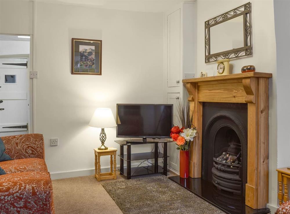 Lovely living room with real flame gas fire in feature fireplace at Laal Yan in Keswick, Cumbria