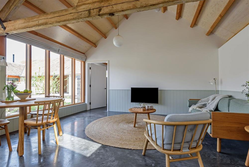 The open-plan day space with exposed beams and an abundance of natural light at Ladymeade, Dorchester