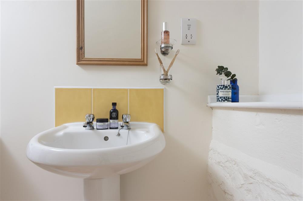 With a bath with over-head shower attachment, heated towel rail, hand basin and WC