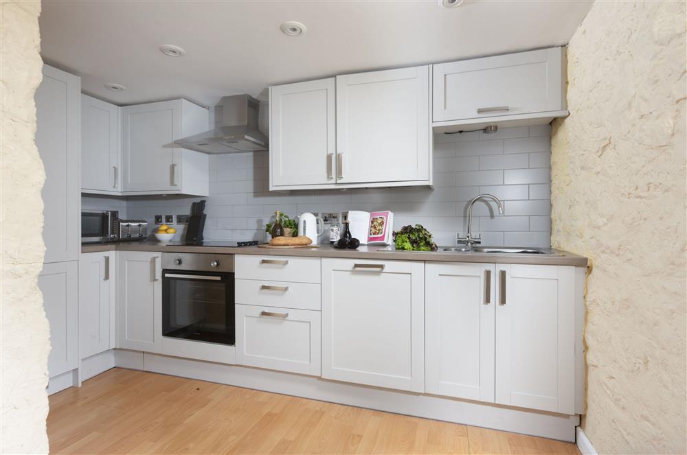 With a electric oven and hob, microwave, fridge/freezer and dishwasher