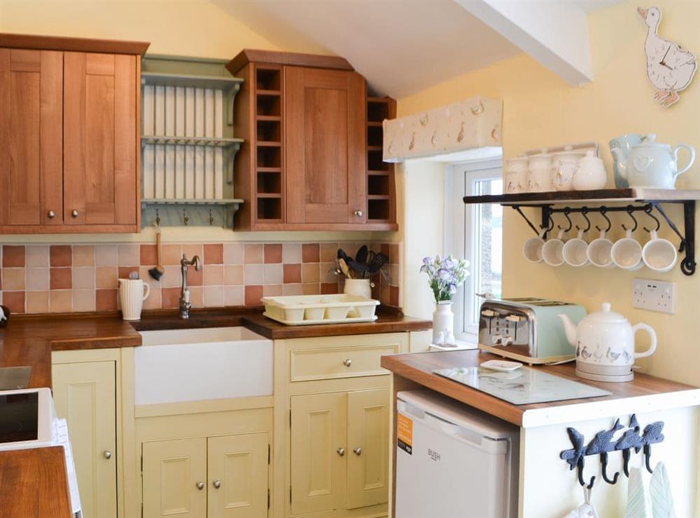 Farmhouse style kitchen with tiled floor at Lake View Cottage in Yarrow Moor, near Bellingham, Northumberland