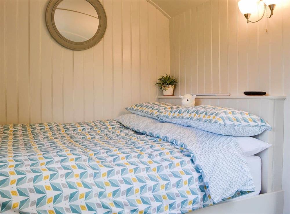 Comfortable and inviting double bed at Lake View Shepherds Hut in Keswick, Cumbria
