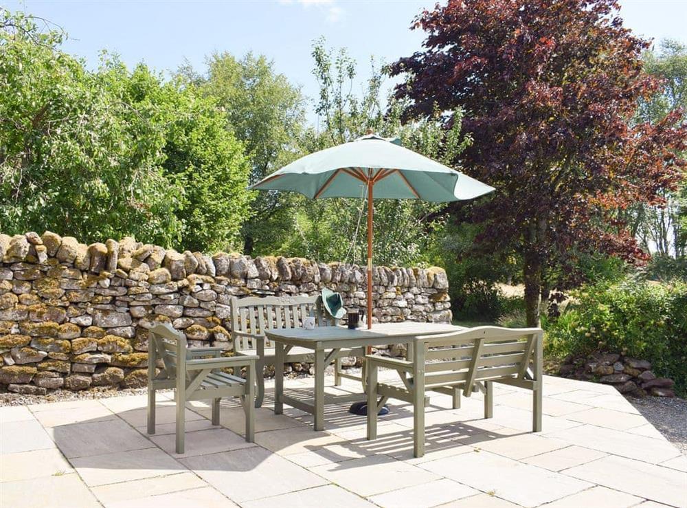 Paved patio area with outdoor furniture at The Old Barn, 