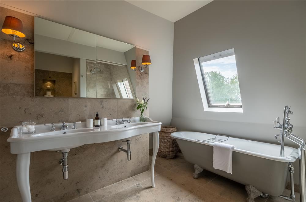 En-suite bathroom with twin wash basins and roll-top bath at Lakeview Oast, Goudhurst