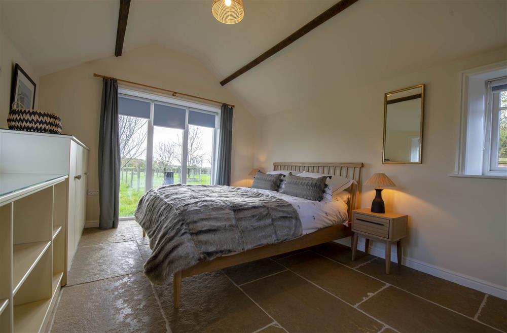 Bedroom one with 5’ king-size bed at LaLo, Thirsk, North Yorkshire