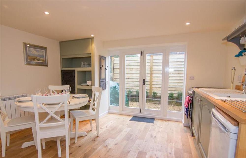 Ground floor:  Open-plan living area with table with seating for four at Lambert Cottage, Snettisham near Kings Lynn