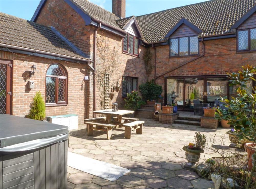 Patio area with hot tub and seating at Lambourne House in Skegness, Lincolnshire