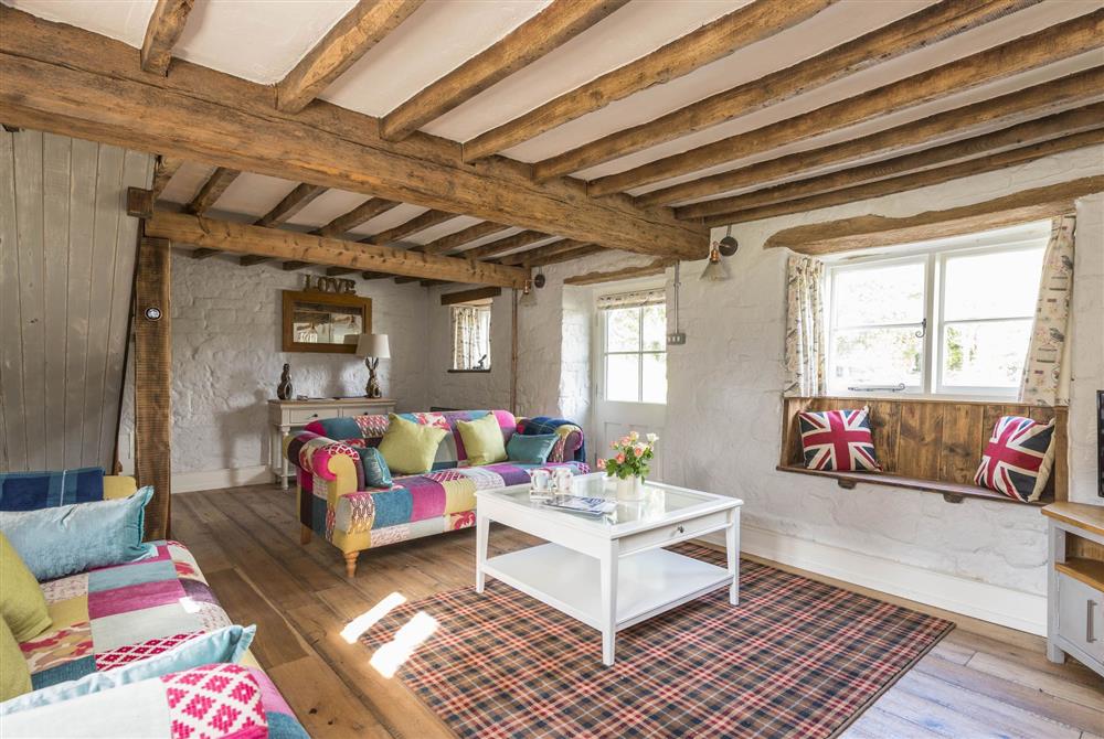 Sitting room with exposed beams at Lanes End Cottage, Dorchester