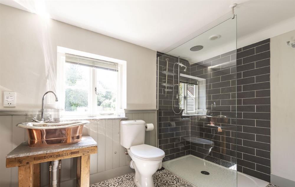 En-suite bathroom with copper bath, wash basin and walk-in shower at Lanes End, Lower Wraxall