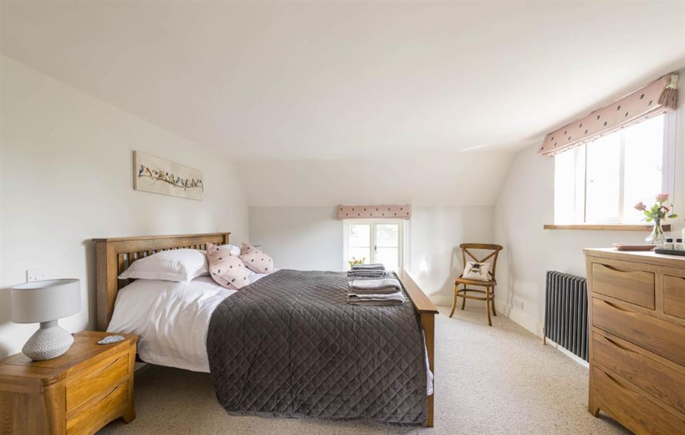 Master bedroom with king-size bed and en-suite bathroom at Lanes End, Lower Wraxall