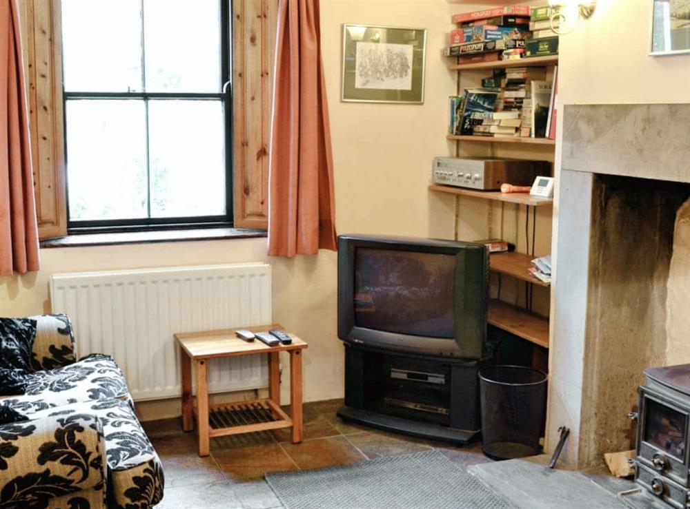 Cosy lounge with wood-burner at Langcliffe Lock Cottage in Langcliffe, near Settle, North Yorkshire