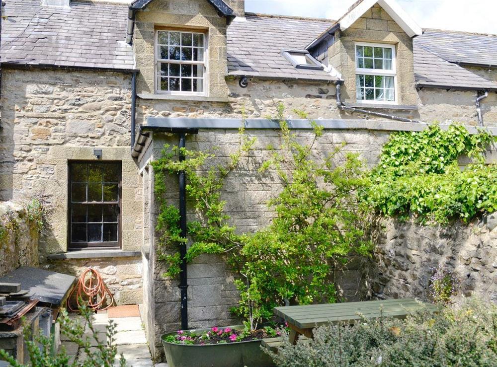 Rear courtyard with sitting out area at Langcliffe Lock Cottage in Langcliffe, near Settle, North Yorkshire