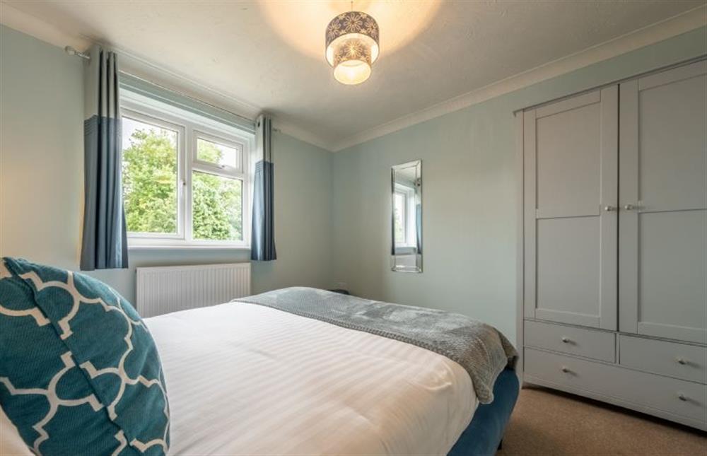 King-size bed in bedroom three at Langdale, Heacham near Kings Lynn