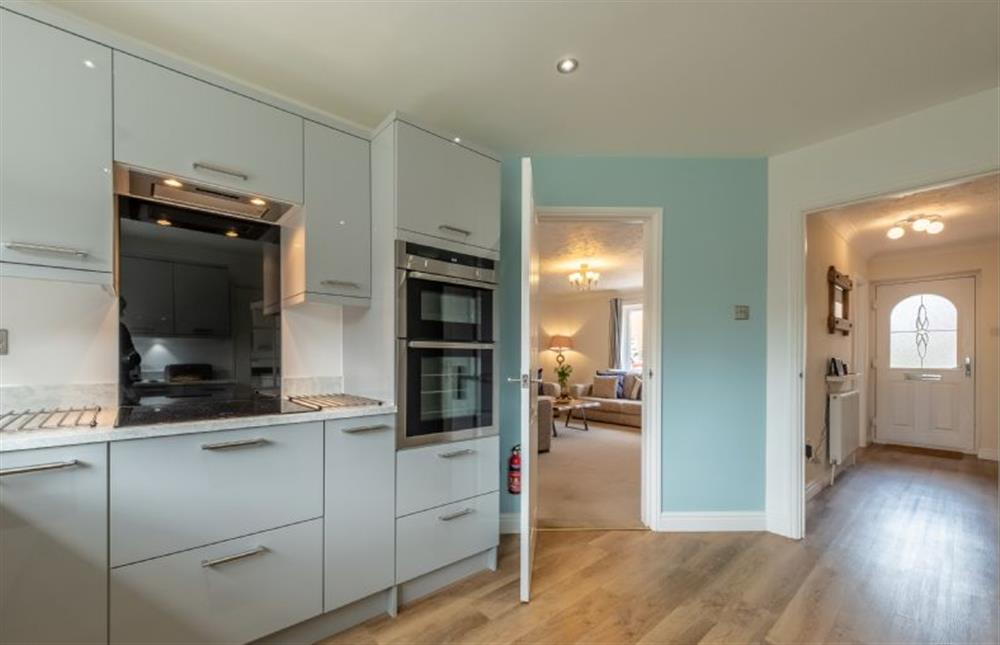 The kitchen is adjacent to the hallway and living area at Langdale, Heacham near Kings Lynn