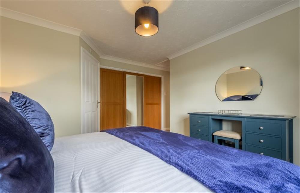 The master bedroom has a super-king size bed at Langdale, Heacham near Kings Lynn
