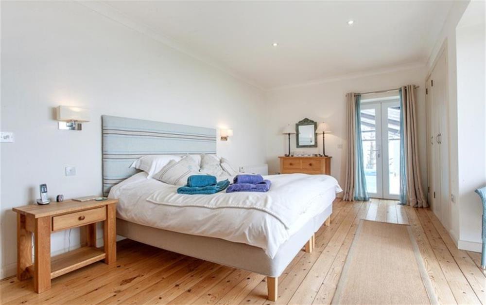 The master bedroom with direct access to the indoor pool at Langerstone in East Prawle