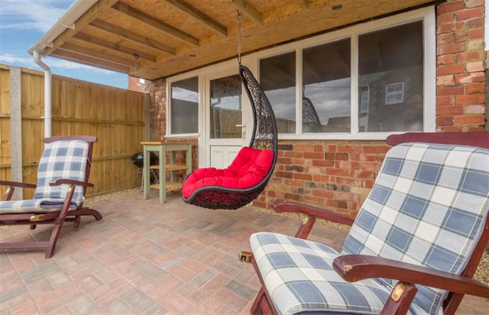 Langleyfts Cottage: Rear garden featuring comfy seating (photo 4) at Langleys Cottage, Heacham near Kings Lynn