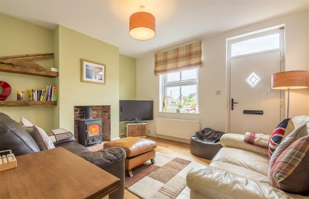 Langleyfts Cottage: Sitting room with a wood burning stove and plenty of comfy seating for 4  at Langleys Cottage, Heacham near Kings Lynn