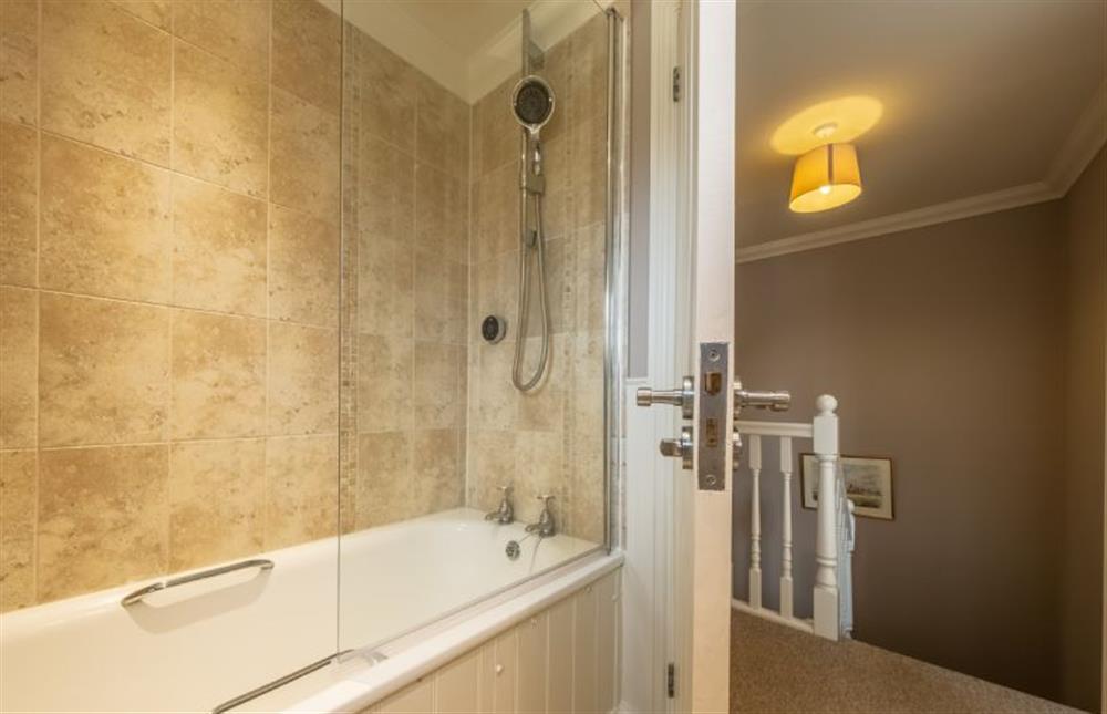 Lantern Cottage: First floor bathroom with a bath and hand held shower  at Lantern Cottage, Wells-next-the-Sea