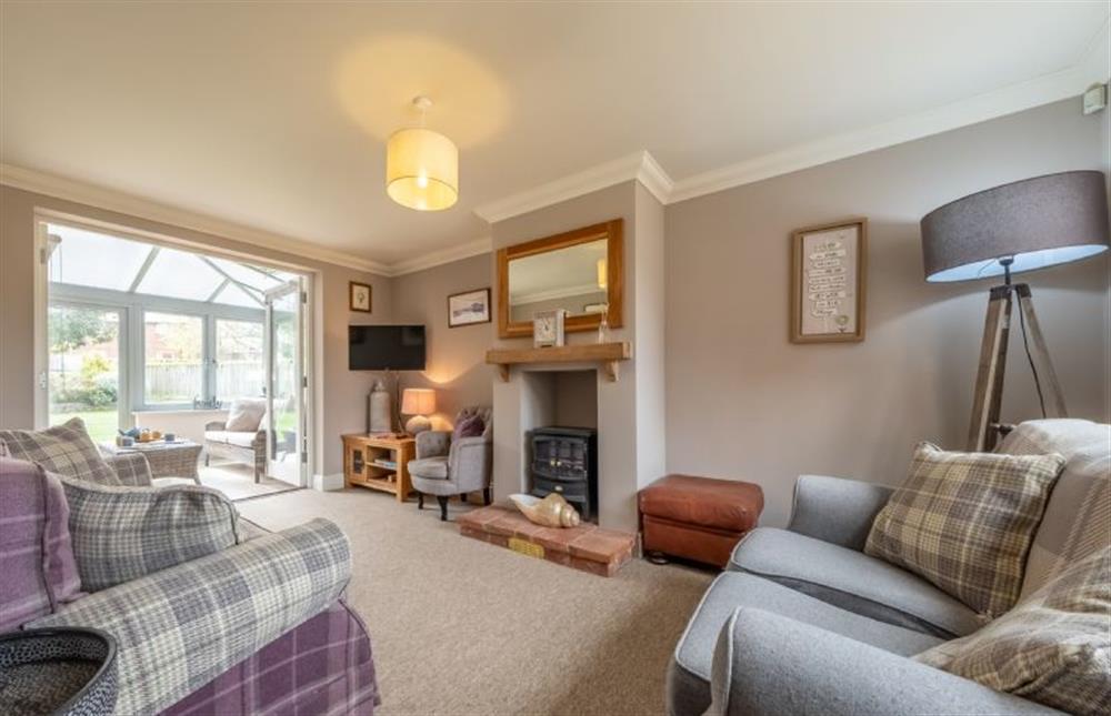 Lantern Cottage: The sitting room has comfortable seating and features a wood burning stove at Lantern Cottage, Wells-next-the-Sea