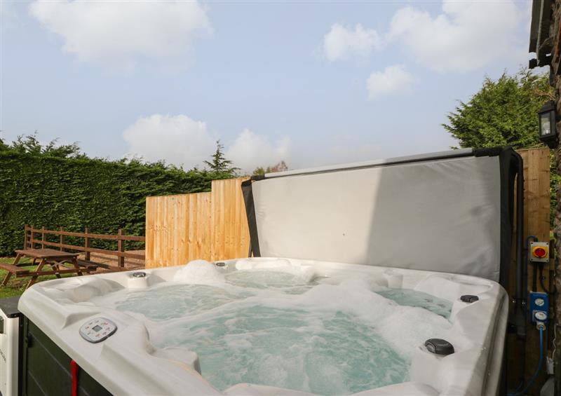 Relax in the hot tub at Larch Bed Cottage, Stanford Bishop near Bromyard