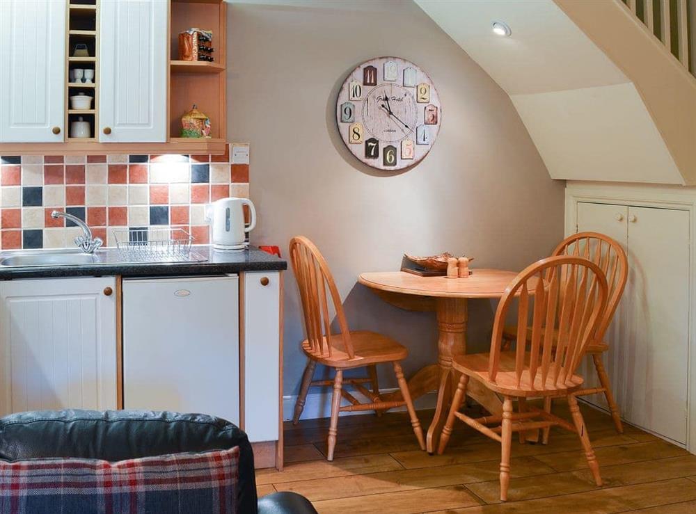 Modest dining area and adjacent kitchen at Larch Cottage in Dunstan, near Alnwick, Northumberland