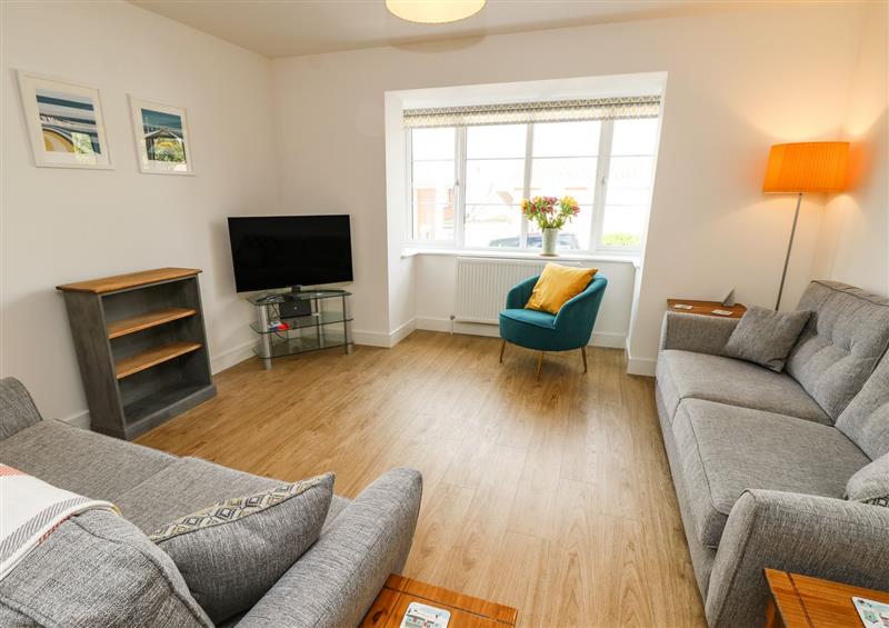 Relax in the living area at Larch Lodge, Totland