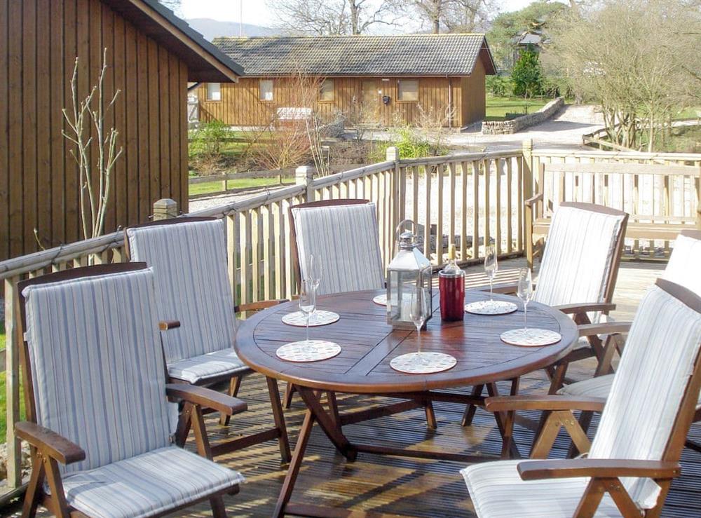 Raised decked area with outdoor furniture at Larchwood in Dukes Meadow, near Greystoke, Cumbria