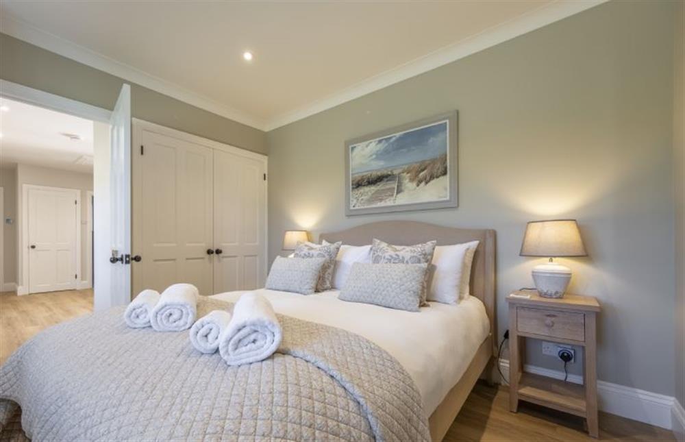 The master bedroom with a 5’ king-size bed at Larks Rise, Burnham Market near Kings Lynn