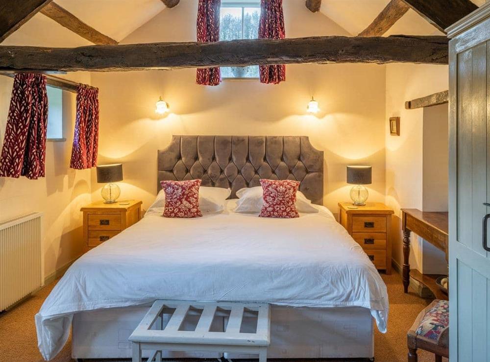 Peaceful double bedroom with exposed wood beams at Foxglove Cottage, 