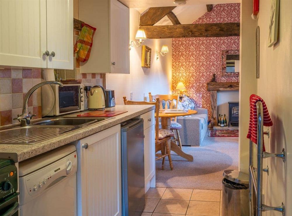 Well-equipped kitchen adjoins the living room at Foxglove Cottage, 