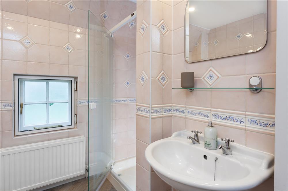 The family bathroom with bath and walk-in shower at Laundry Cottage, Arley