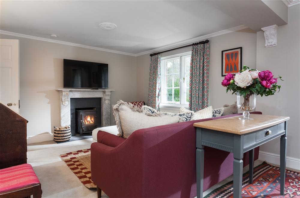The sitting room boasts a wood burning stove at Laundry Cottage, Arley
