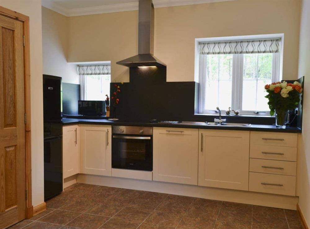Large kitchen with tiled floor at Laundry Cottage in Ceannacroc, Inverness-shire. , Inverness-Shire