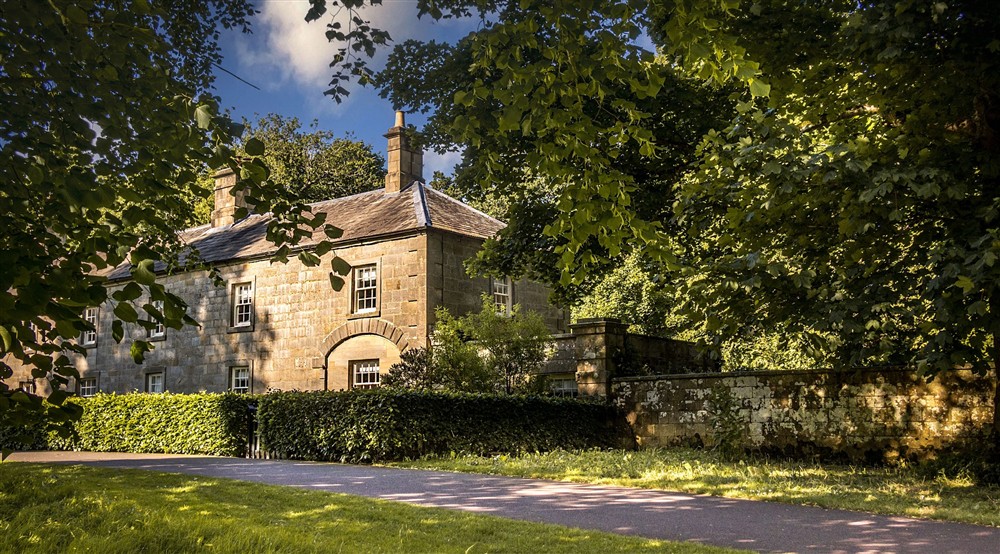 The front exterior of Laundry Cottage and the path that leads past it towards the house at Laundry Cottage in Morpeth, Northumberland