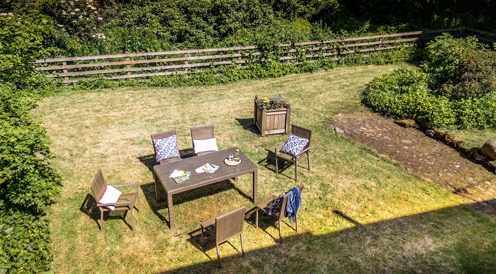 The lawned garden with dining furniture for six (photo 2) at Laundry Cottage in Morpeth, Northumberland