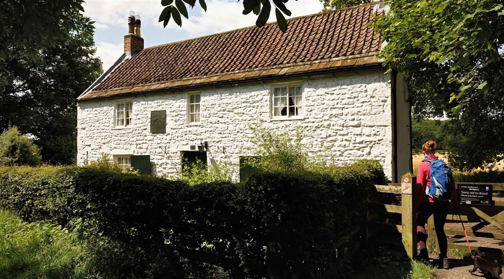 Visitor outside George Stephensons Birthplace, Northumberland at Laundry Cottage in Morpeth, Northumberland