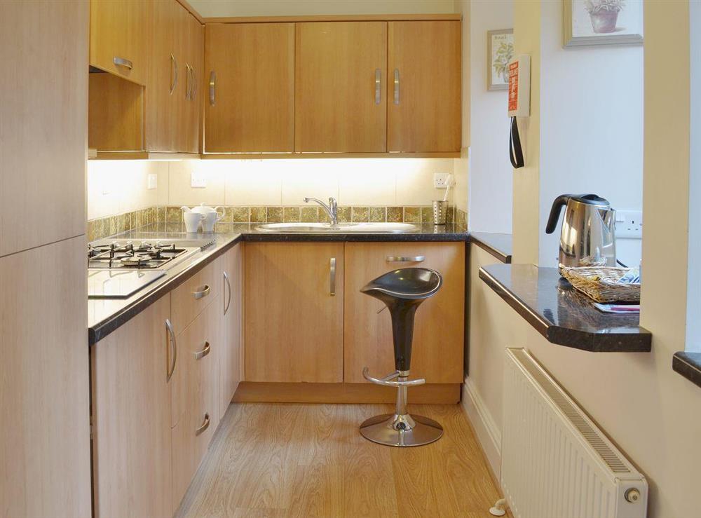 The galley style kitchen is well-equipped at Laurel Cottage in Torquay, Devon