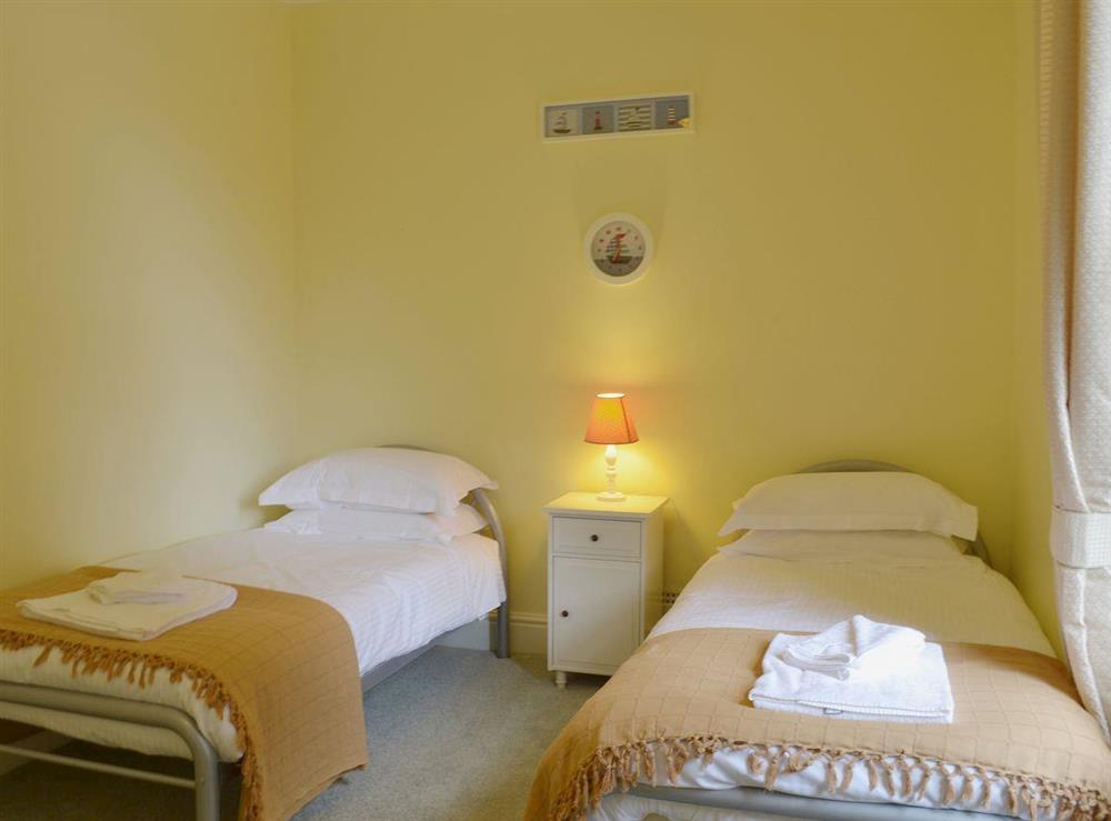 The twin bedroom is comfortably furnished at Laurel Cottage in Torquay, Devon