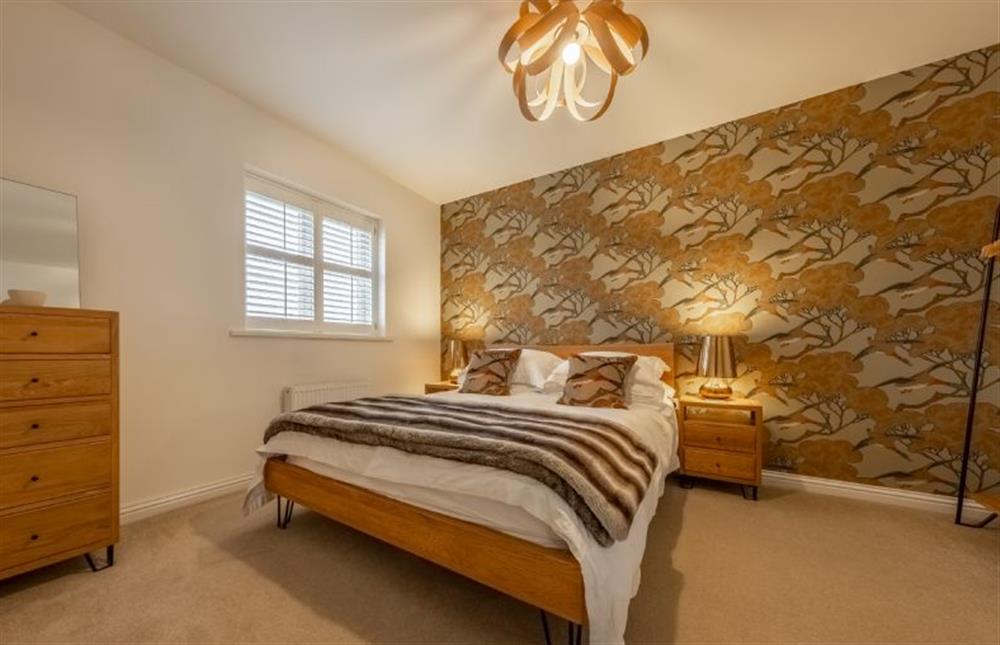 First floor: Master bedroom with a king-size bed at Lavandula, Burnham Market near Kings Lynn