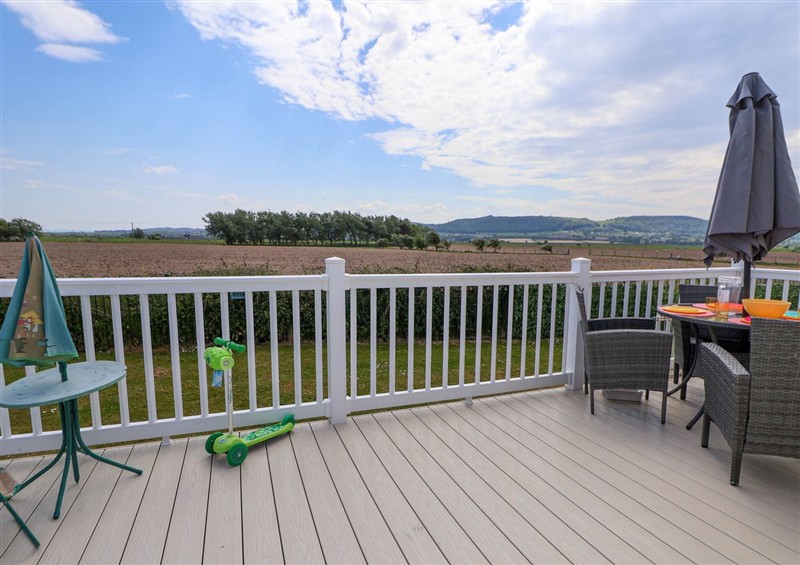 Enjoy a glass of wine on the patio at Lawi39, Towyn