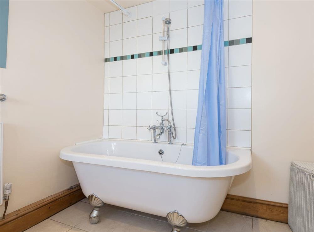 Bathroom featuring standalone bath with shower at Lazy Cottage in Haverigg, near Millom, Cumbria