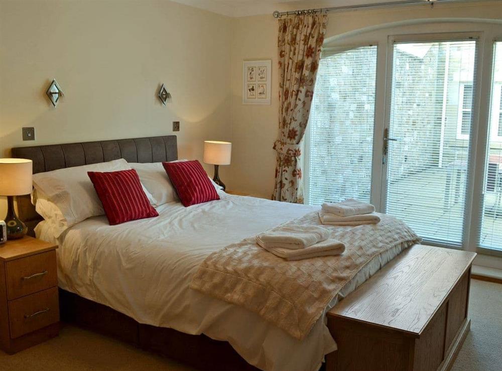 Sumptuous double bedroom with kingsize bed and en-suite at Lazy Puffin in Beadnell, near Alnwick, Northumberland