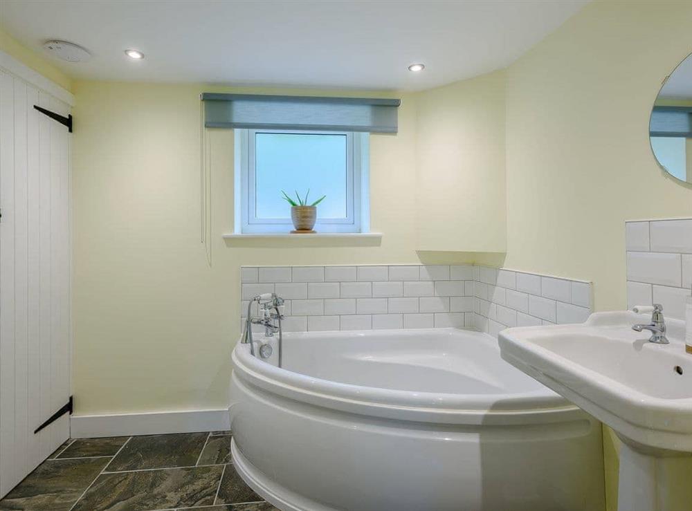 Bathroom with corner bath at Leatherpool Place in Wiveton, near Holt, Norfolk