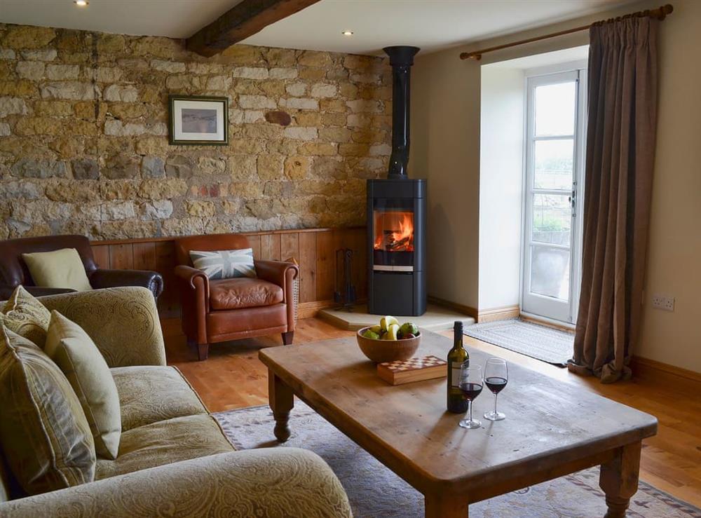 Cosy living room with wood burner at Mullins Cottage, 