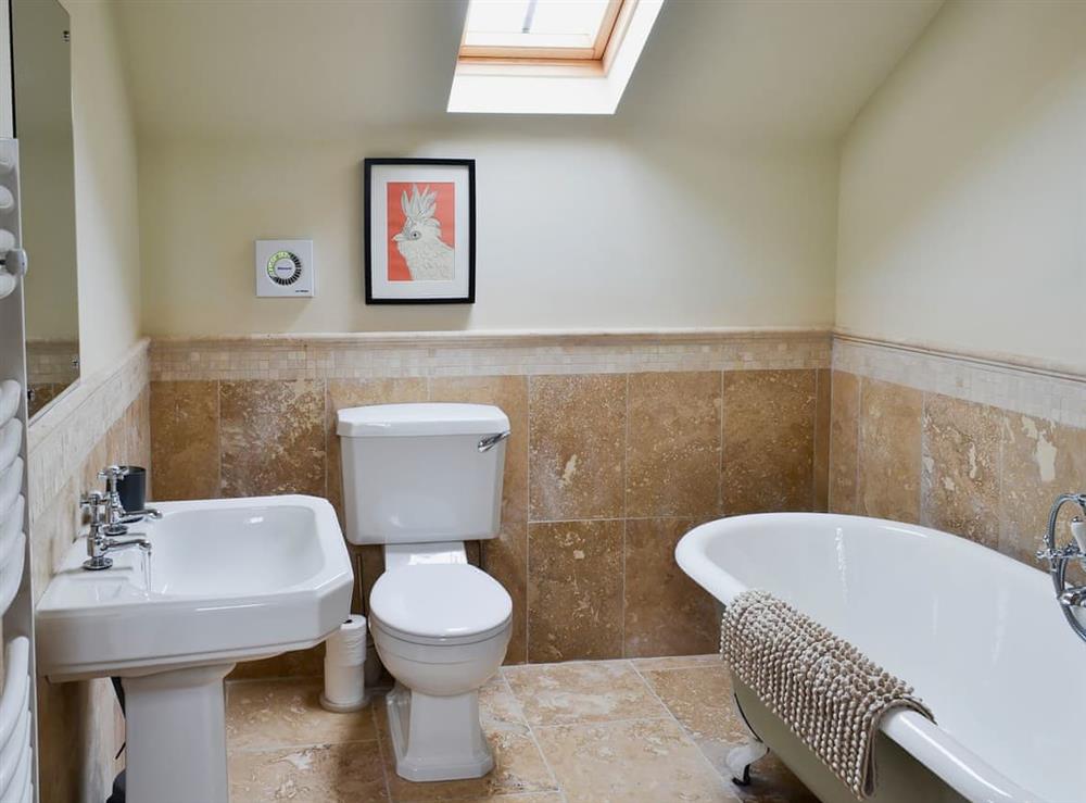 Spacious bathroom with roll top bath and shower over bath at Mullins Cottage, 